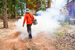 Unidentified man is spraying chemical for an outbreak of dengue fever at the countryside.