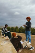 © BONNINSTUDIO/Stocksy - Diverse friends studying in park