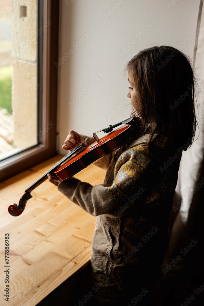 young girl playing the violin Stock Photo | Adobe Stock