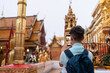 © Alvaro Lavin/Stocksy - Tourist with mobile phone at a temple.