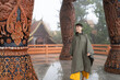 © Alvaro Lavin/Stocksy - Smiling tourist woman at a temple.