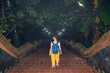 © Alvaro Lavin/Stocksy - Woman at Wat Doi Suthep temple stairs.