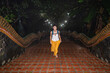 © Alvaro Lavin/Stocksy - Woman at Naga stairs of Wat Doi Suthep.