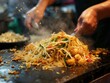 The perfect toss of Pad Thai a skill honed on the vibrant streets