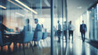 © melhak - Blurry Office Meeting Through Glass Wall: Focusing on Corporate Teamwork and Workplace Dynamics.