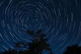 Fototapeta Dziecięca - Time-Lapse Sequence Showing The Rotation of The Night Sky Around The Celestial Pole, Generative AI