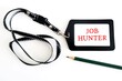 Office ID card with text written JOB HUNTER- concept of person in job hunting or seeking employment - looking for a job