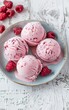 Scoops of Raspberry Ice Cream on a Ceramic Plate Adorned With Fresh Berries
