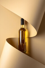 Poster - Bottle of white wine on a beige background.