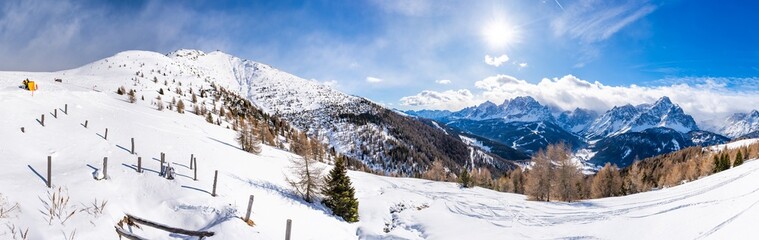 Wall Mural - Wide panoramic view of winter landscape with snow covered Dolomites in Kronplatz, Italy