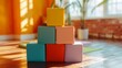 A stack of colorful yoga blocks arranged neatly in a well-lit studio corner