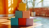Fototapeta  - A stack of colorful yoga blocks arranged neatly in a well-lit studio corner