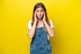 Fototapeta Na drzwi - Young caucasian woman isolated on yellow background frustrated and covering ears