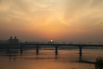 The morning sun rising above the Han River Bridge in Seoul