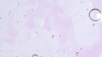 Wall Mural - Motion of molecule bubbles in a cosmetic serum, macro. Pink transparent cosmetic gel fluid with molecule bubbles.