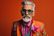 Stylish senior man portrait. Fashionable grandfather with hipster mustache and beard wearing extravagant clothes. Funny old man, fashion model on colored background