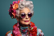 Stylish senior woman portrait. Cute grandmother wearing extravagant clothes with eclectic accessories. Funny old woman with grey hair, fashion model on colored background