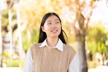 Wall Mural - Pretty Chinese woman at outdoors . Portrait