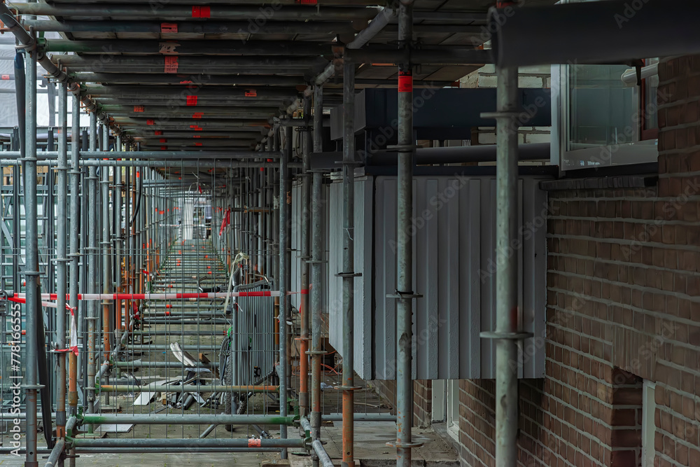 view of steel scaffolding pipes next to an apartment building