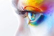 A woman's eye is painted with rainbow colors