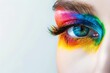 A woman's eye is painted with a rainbow of colors