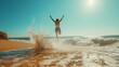 © SKW - A man is jumping into the ocean with his arms outstretched. The water is choppy and the sky is clear