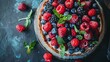 A homemade cheesecake adorned with fresh berries and mint, offering a delightful and healthy organic summer dessert option.