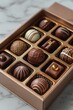 A tiny 3D box of assorted chocolate bonbons on a simple background