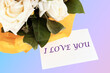 words I love you on a white business card on a colored background