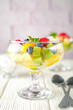 Fresh fruit salad on a light wooden table background