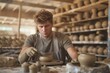 © Anastasiia S - Young blonde man in a wheelchair in t-shirt working on a pottery wheel. Disabled person without the ability to move independently. Concept inclusivity, healthcare, art therapy.