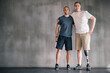 happy, physiotherapist and man with disability in portrait with prosthetic leg in mockup space. Studio, background and orthopedic healthcare or rehabilitation for disabled male person with smile