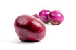 Large and small red onions isolated on white with selective focus