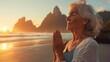 Elderly Woman Embracing Peace with Sunrise Yoga. An elderly woman in a peaceful yoga pose is bathed in the warm light of sunrise on a tranquil beach, reflecting a harmony with nature.