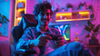 young smiling man playing video games in his bedroom, esports, pink lights