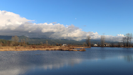 Wall Mural - Dark clouds above mountains in cold winter day