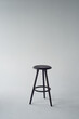 Black high chair on white background. Minimalism in design and life.