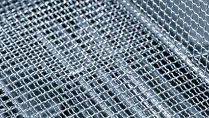 Poster - A close up of a metal mesh with a silver color. The mesh is made of metal and has a pattern