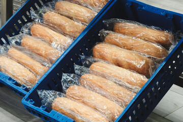 Poster - A blue container with plastic bags of bread inside