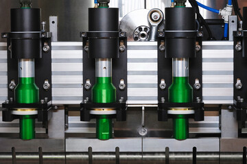 Leinwandbilder - A machine with four green cylinders on it