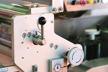Poster - A machine with a white knob on it. The knob is black and has a green dot on it