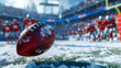 A football dusted with snow lies in focus with blurred players and stadium in the background