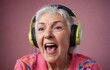 An elderly woman with headphones on, singing happily into them