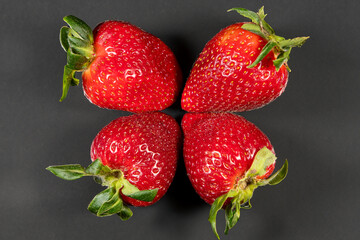 Wall Mural - Close-up with red strawberries on a dark background, perfect for design, ornamental or wallpaper