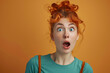 Surprised redhead woman in green shirt with wide eyes