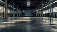 A Large Empty Warehouse With Tall Windows Lining The Upper Walls. Sunlight Streams Through The Windows. Concrete Floor.