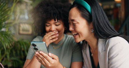 Canvas Print - Happy women, friends and phone for social media at coffee shop for news, gossip or networking together. Young people smile and laughing on mobile smartphone for funny joke or meme at cafe restaurant