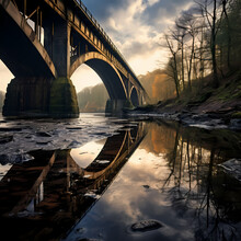 Reflection Of A Bridge In Still Water.
