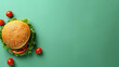 A delicious hamburger with sesame bun presented on a green backdrop, seamless for a banner with blank space concept