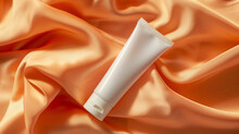 White Cosmetic Tube On Orange Velvet Clothing Background